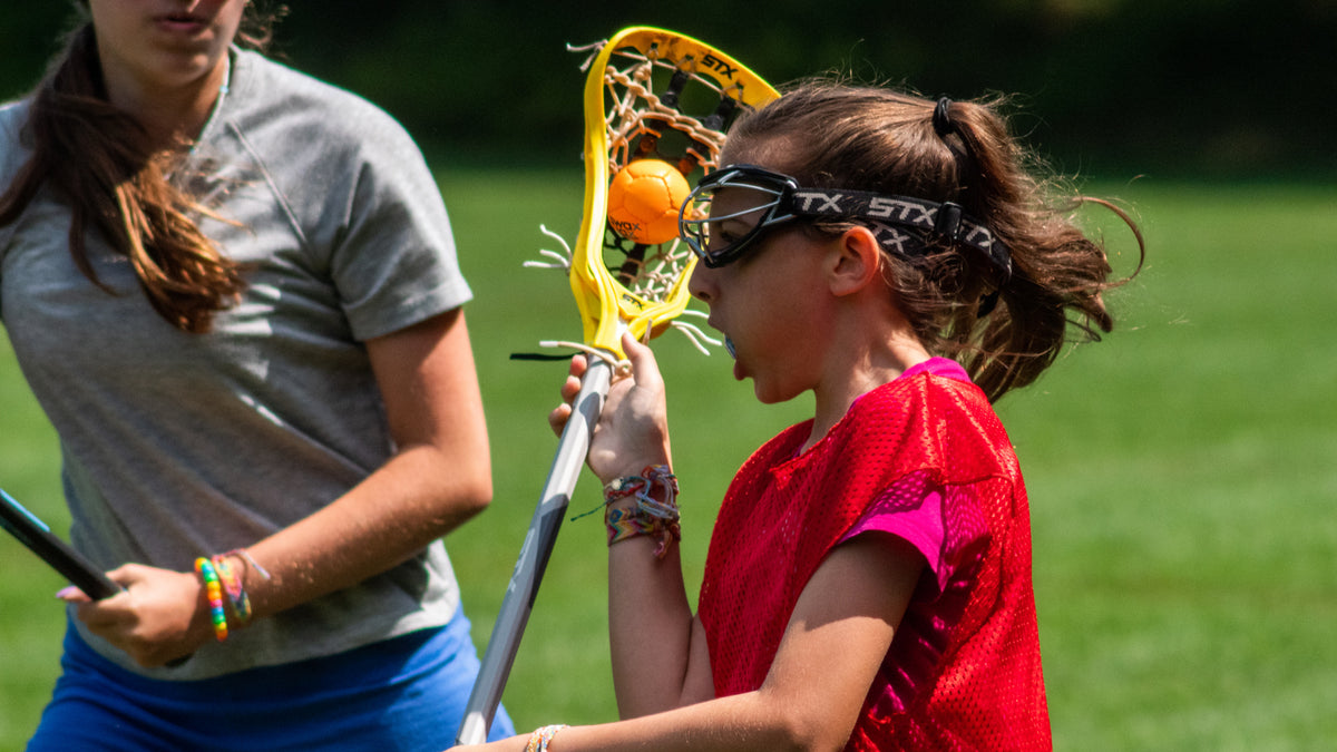 Girls lacrosse player with Swax Lax ball in stick