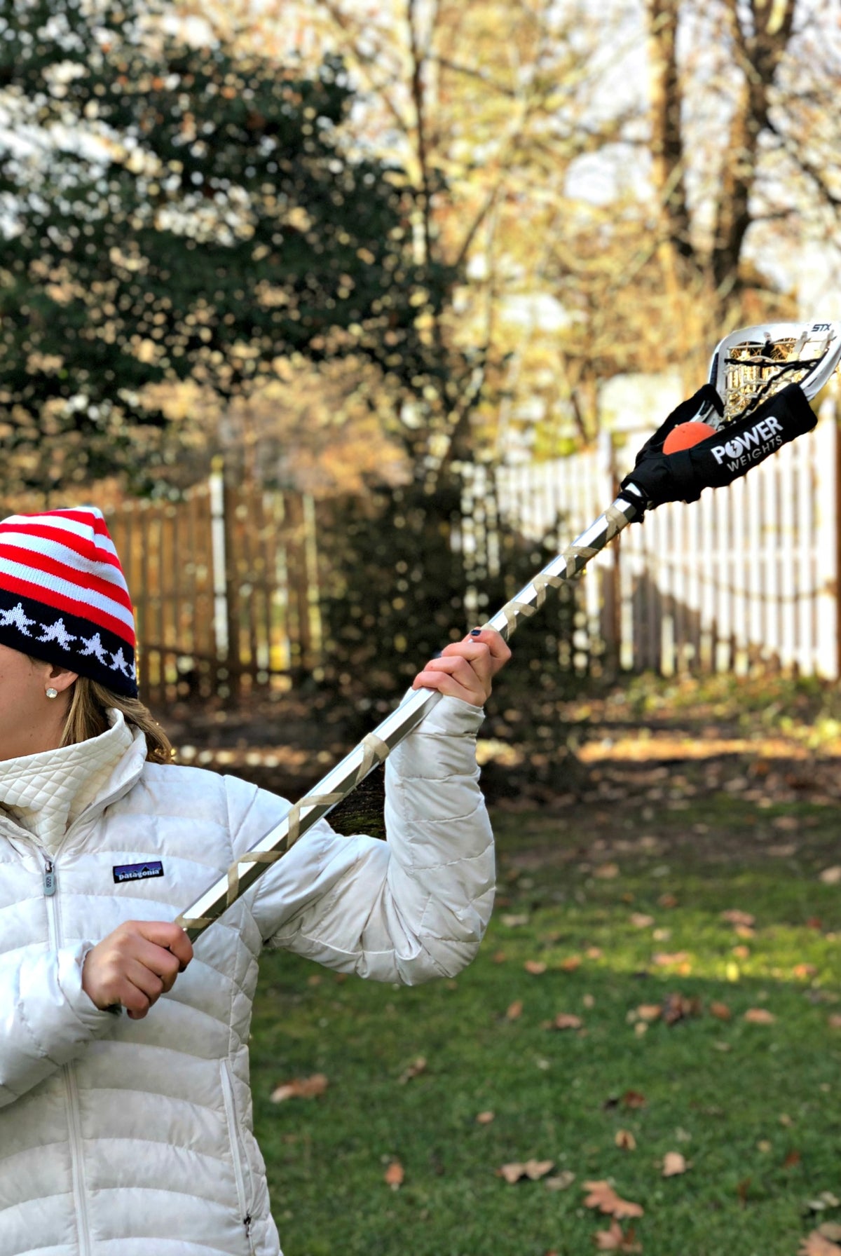 Swax Lax Power Weights shown on lacrosse stick